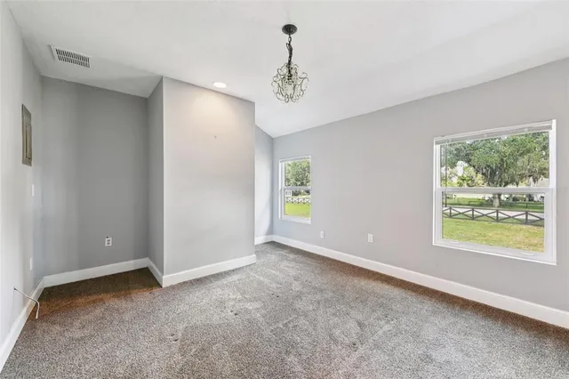 an aerial view of a house with a yard and trees