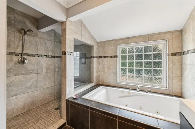 an aerial view of residential house with outdoor space and trees