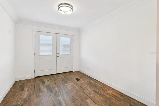 a view of a livingroom with a fireplace a ceiling fan and windows