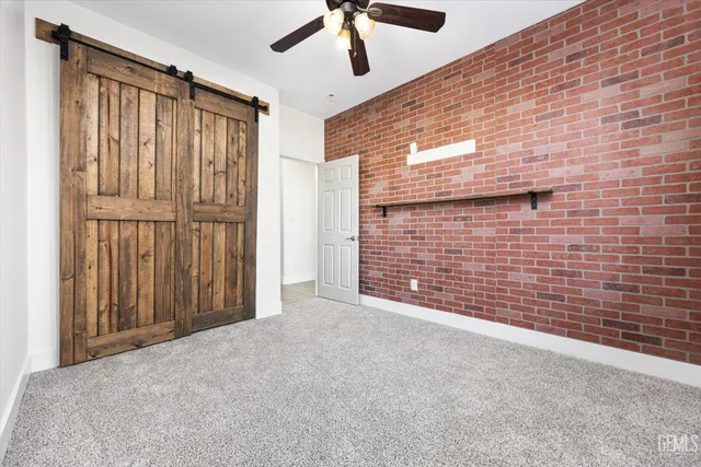a kitchen with stainless steel appliances kitchen island granite countertop a sink stove and refrigerator