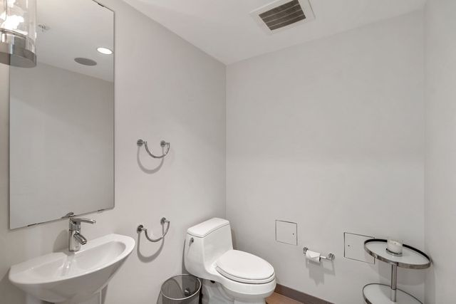 a white toilet sitting next to a bathroom sink