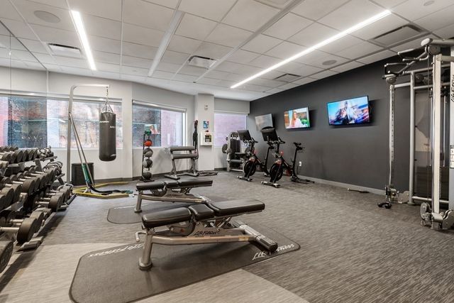 a room with gym equipment and a large window