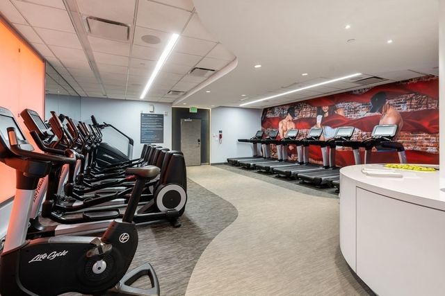 a room with gym equipment and a flat screen tv