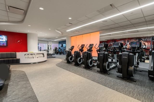 a living room with lots of furniture and a gym