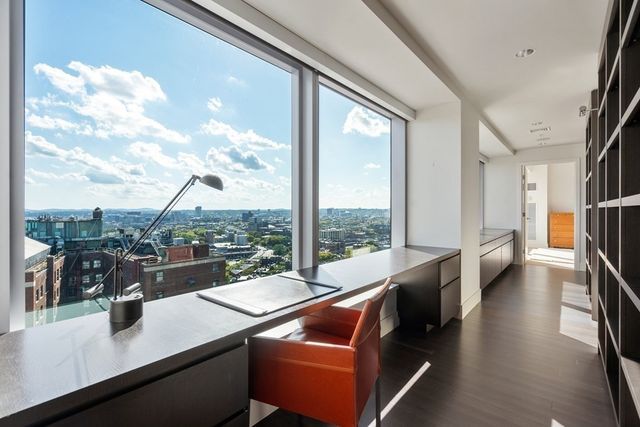 a view of a living room with furniture and a floor to ceiling window