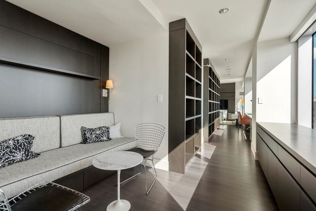 a hallway with furniture and wooden floor