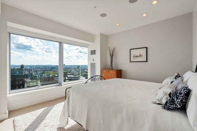 a bedroom with a large bed and a large window