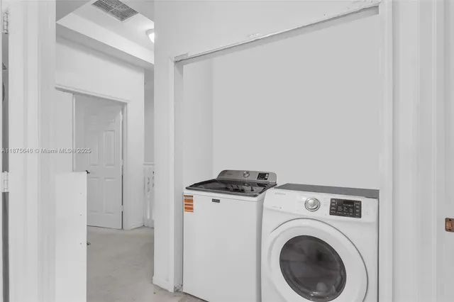 a view of storage and utility room with washer and dryer