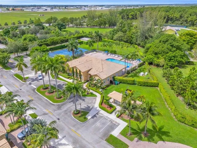 an aerial view of a house with garden space and street view
