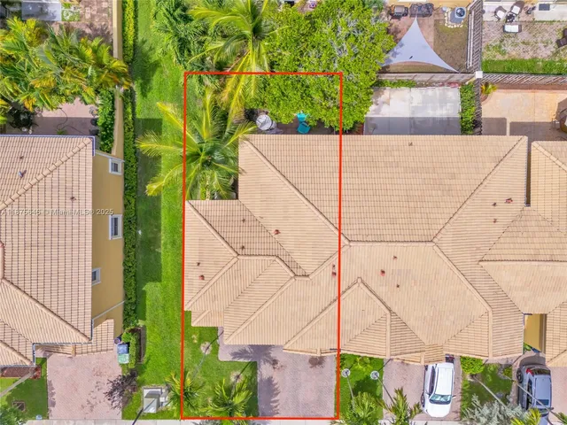 an aerial view of multiple houses with yard