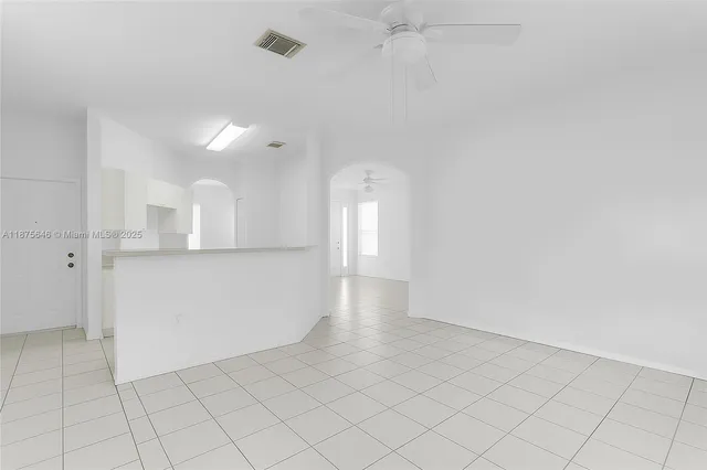 an empty room with cabinet and mirrors