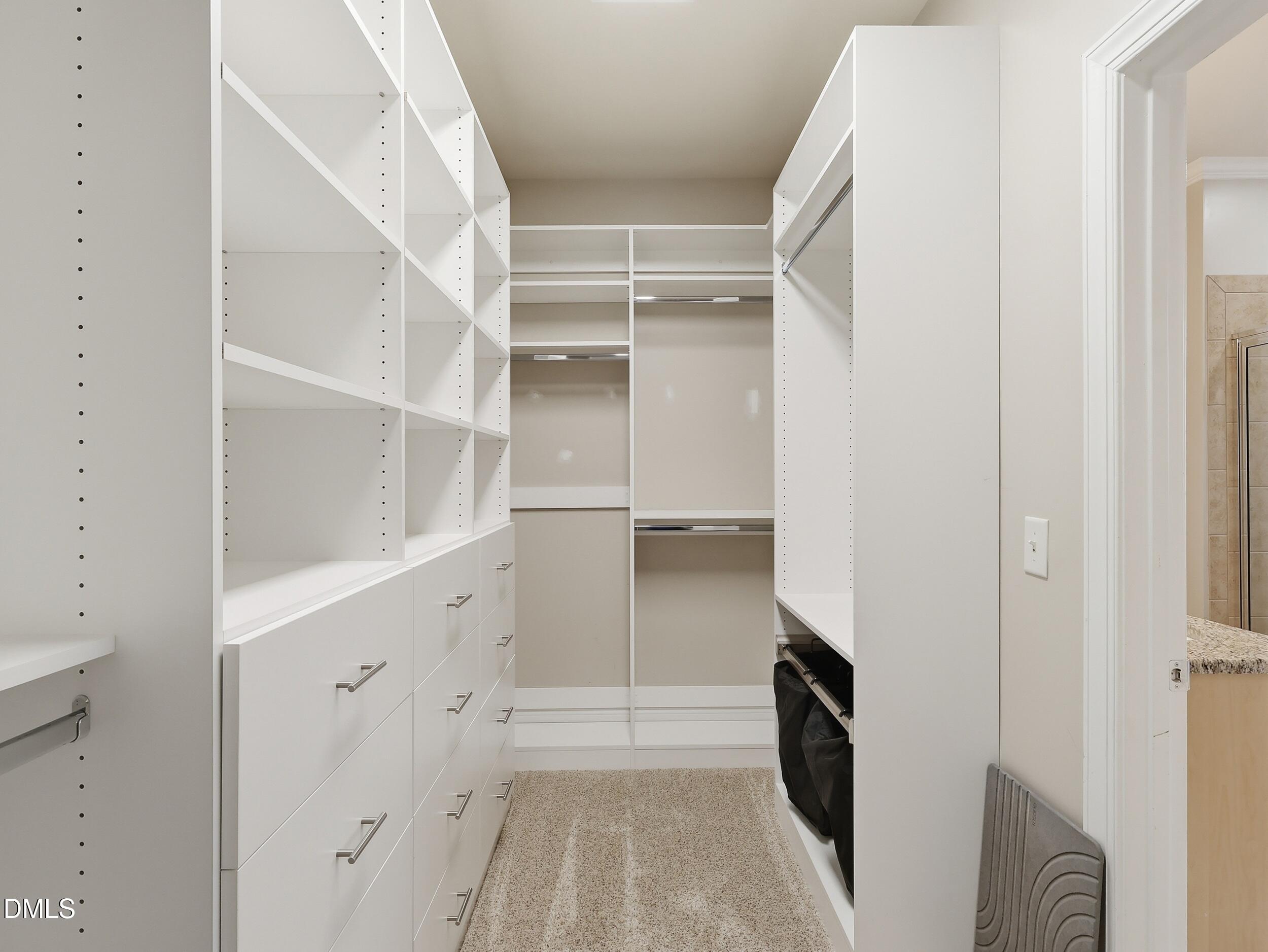 208 Brookberry Road Holly Springs, NC 27540 - Photo 14 of 32 a view of walk in closet with empty racks