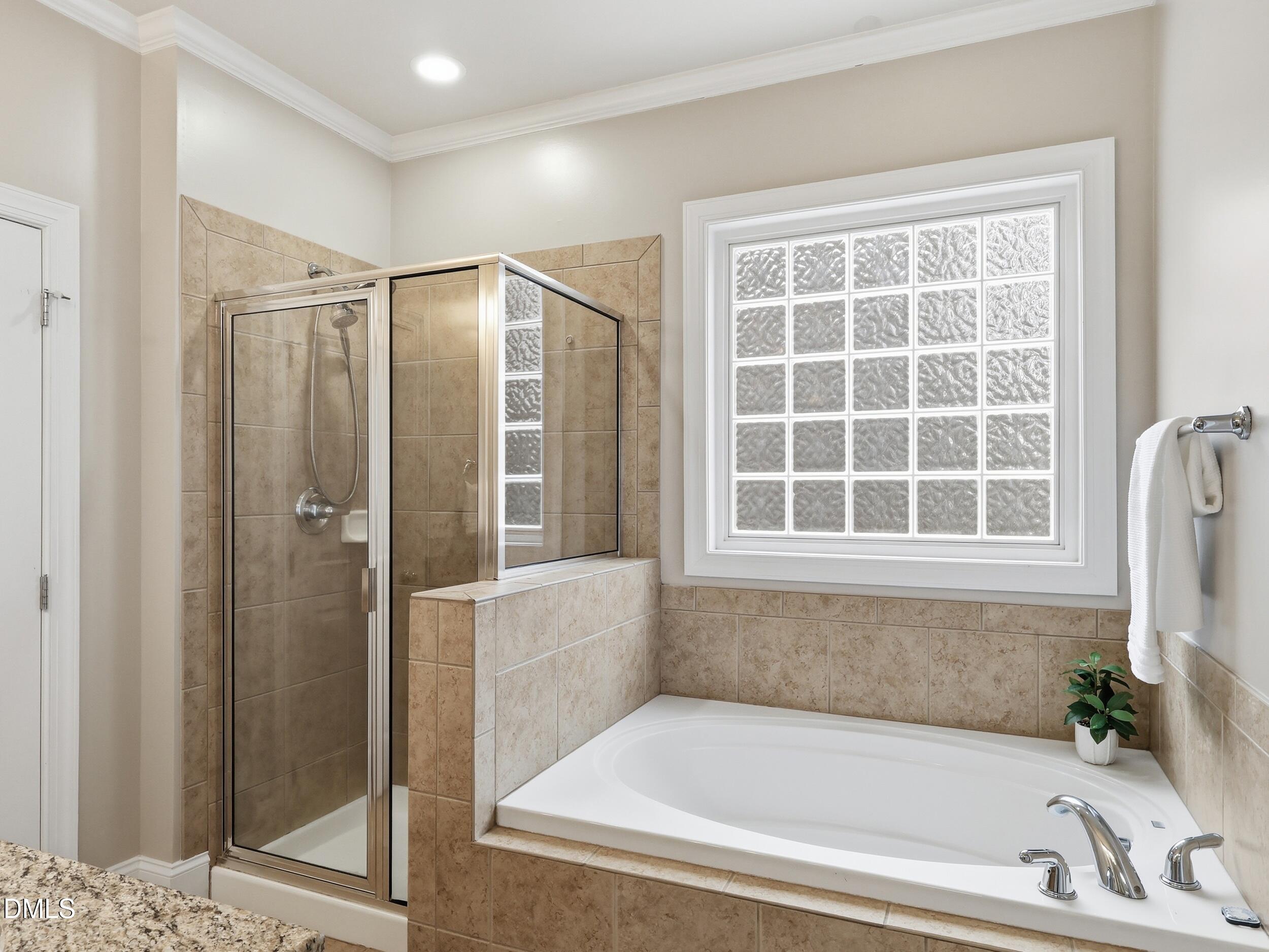 208 Brookberry Road Holly Springs, NC 27540 - Photo 15 of 32 a bathroom with a bathtub and shower