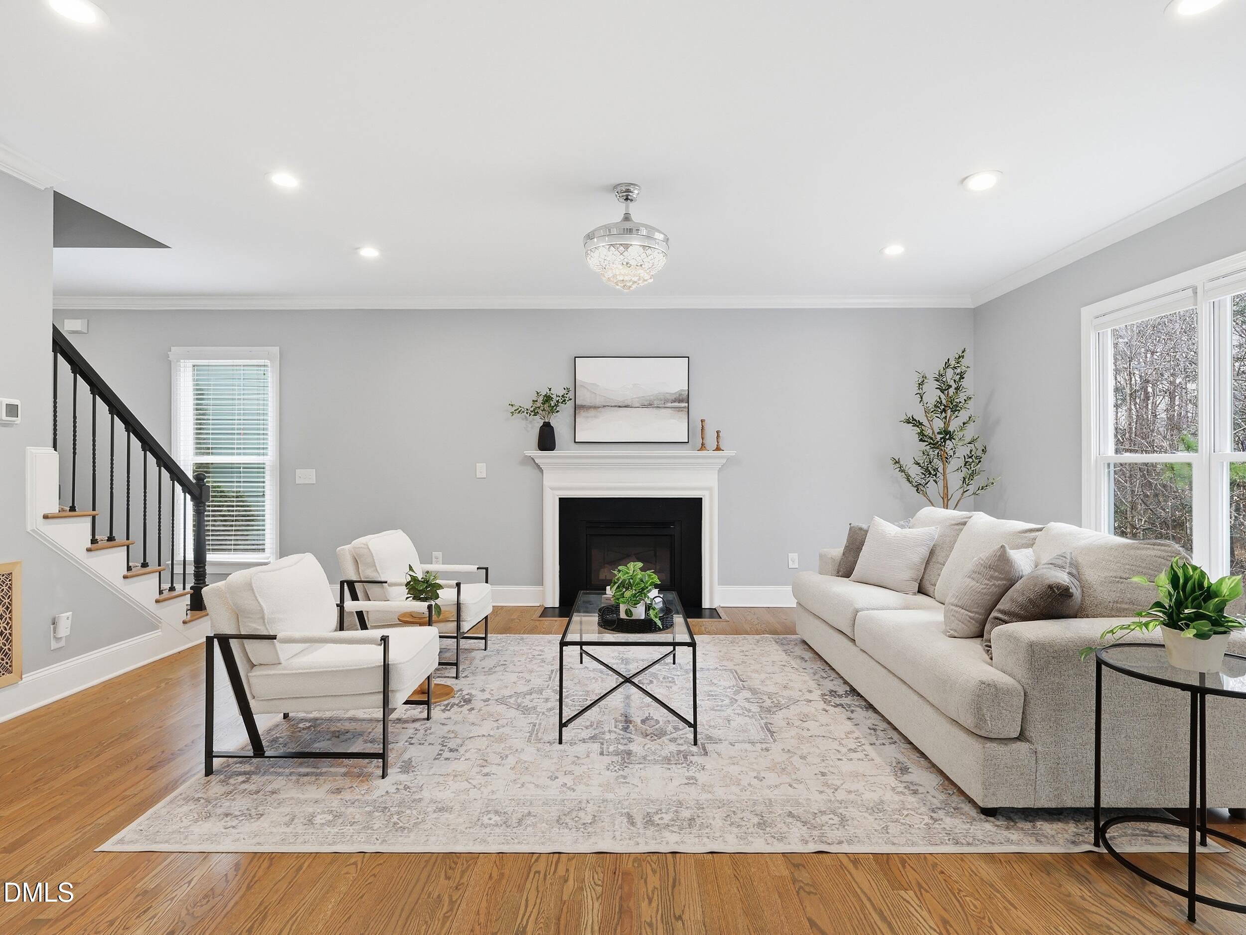 208 Brookberry Road Holly Springs, NC 27540 - Photo 3 of 32 a living room with furniture and a fireplace