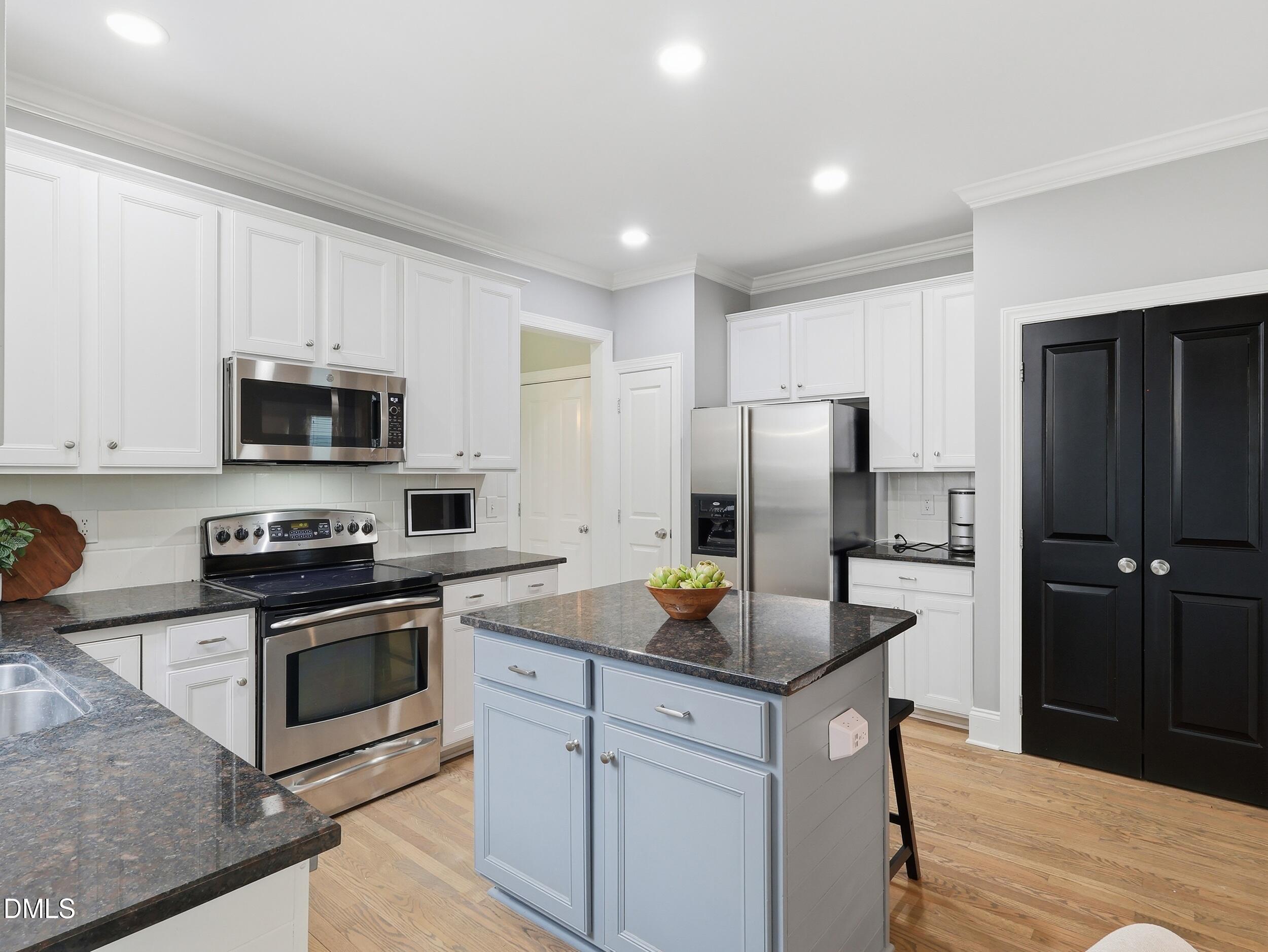 208 Brookberry Road Holly Springs, NC 27540 - Photo 9 of 32 a kitchen with stainless steel appliances granite countertop a refrigerator stove microwave and sink