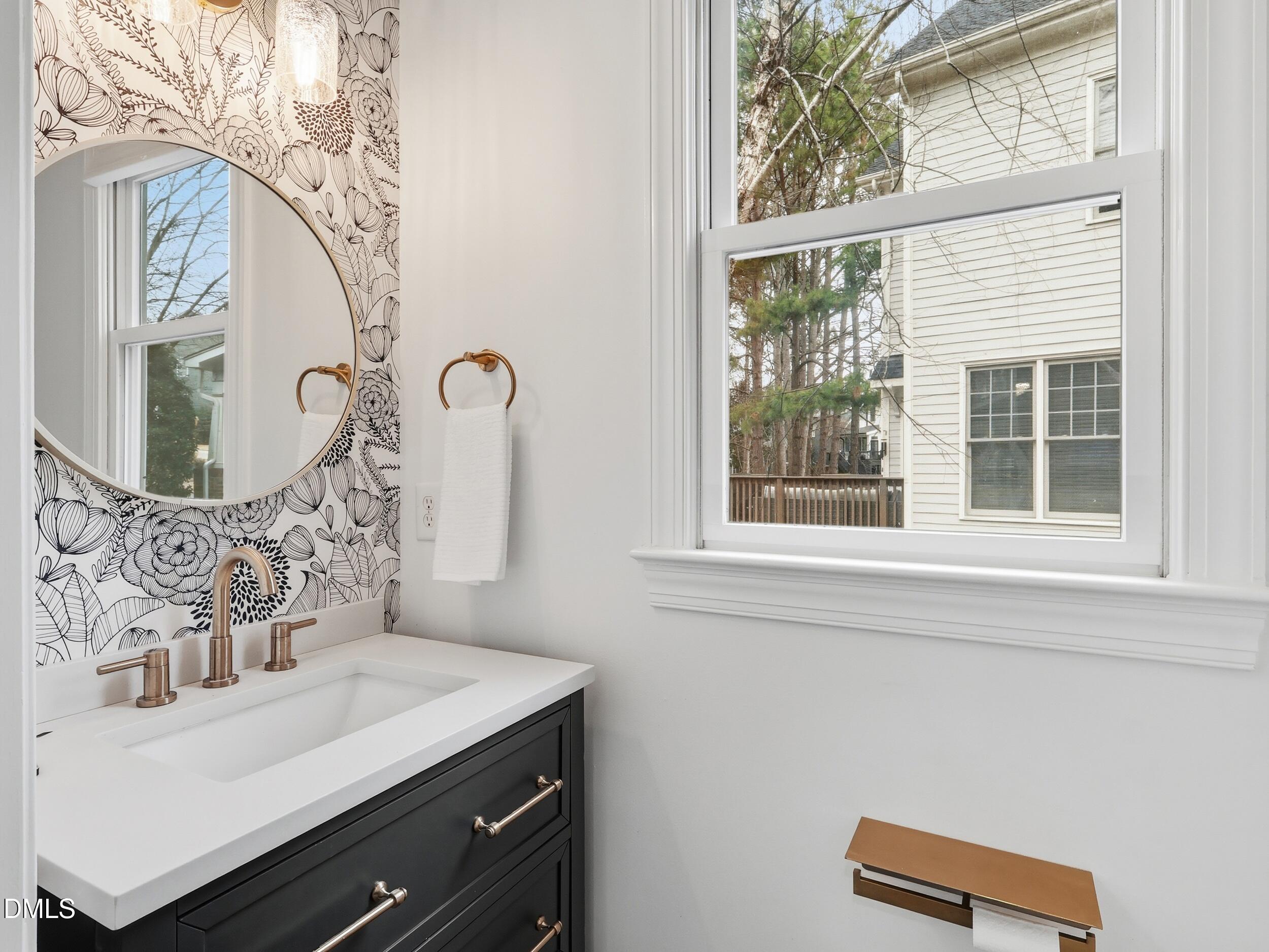 208 Brookberry Road Holly Springs, NC 27540 - Photo 10 of 32 a bathroom with a sink and a mirror