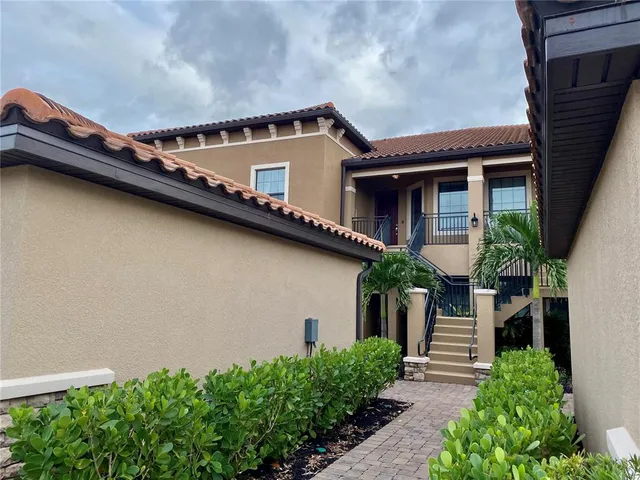 a front view of a house with plants