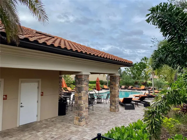 a view of a porch with chairs and backyard