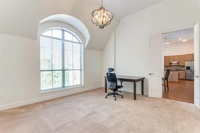 a view of a livingroom with a piano and a window