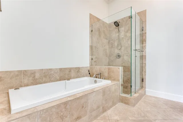 a spacious bathroom with a bathtub and shower