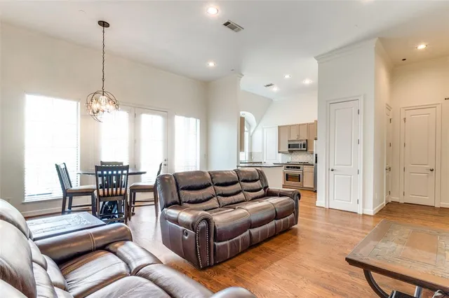 a living room with furniture and a dining table