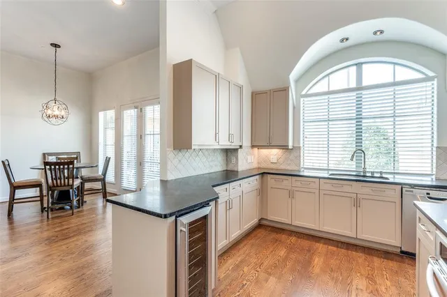 a kitchen with stainless steel appliances granite countertop a stove a sink and a dining table with granite countertop