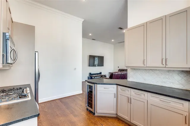 a kitchen with stainless steel appliances granite countertop a sink and a stove