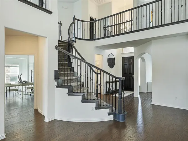a view of entryway and hall with wooden floor