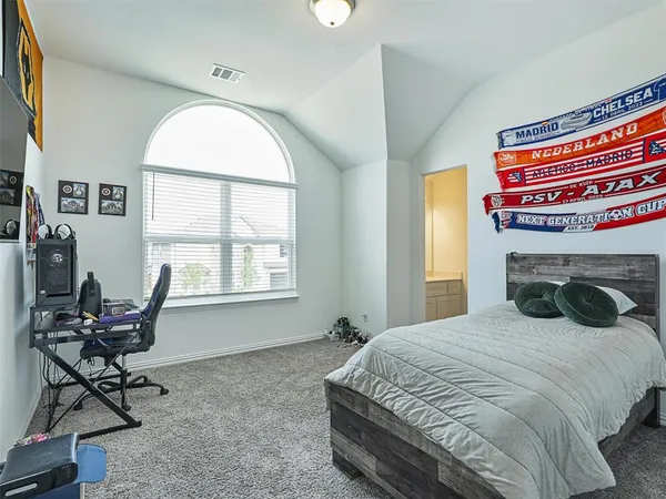 a bedroom with a bed chair and a window