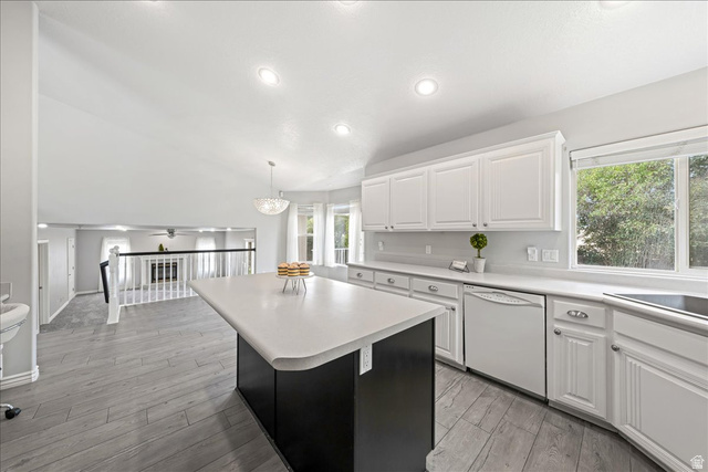 7 Reflection Way St. George, UT 84770 - Photo 16 of 54 Kitchen featuring white cabinets, light countertops, white dishwasher, light wood-type flooring, and pendant lighting
