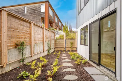a kitchen with stainless steel appliances a table chairs refrigerator and cabinets