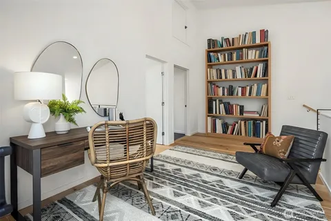 a bedroom with a large bed and a potted plant