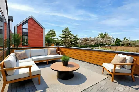 a outdoor sitting area with a couch and a potted plant