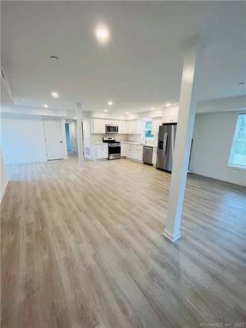 a kitchen with stainless steel appliances a refrigerator and a stove top oven