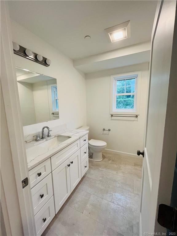 54 School Street Bridgeport, CT 06605 - Photo 4 of 9 a bathroom with 2 sink toilet and a mirror