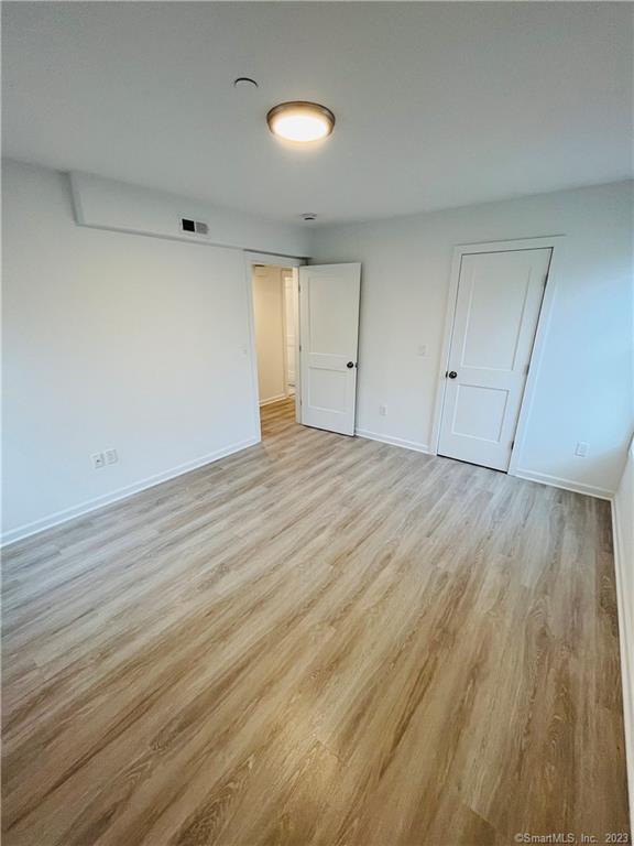 54 School Street Bridgeport, CT 06605 - Photo 5 of 9 wooden floor in an empty room