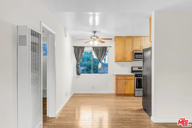 a view of a kitchen with a sink and dishwasher wooden floor