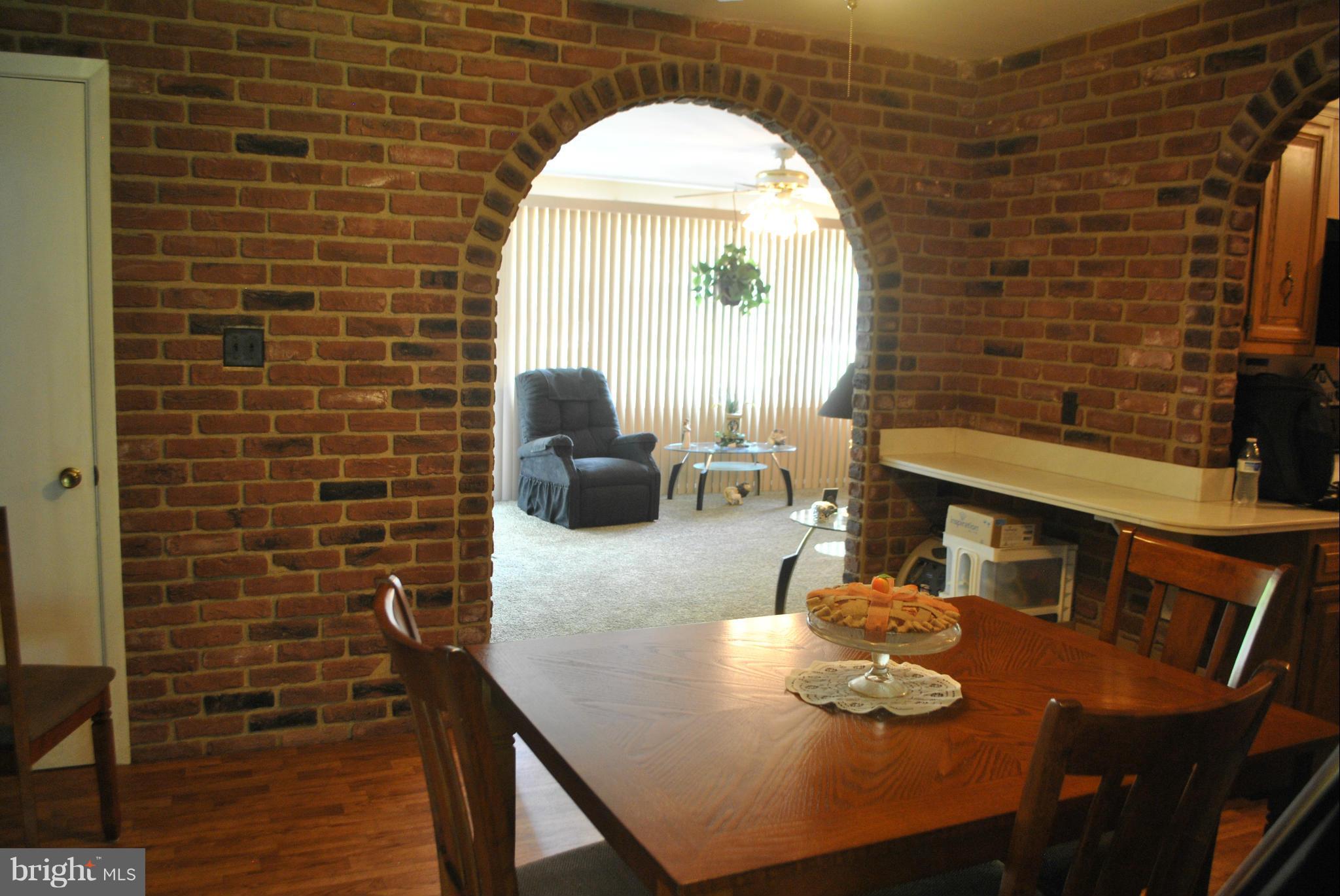 1810 Willann Road Baltimore, MD 21237 - Photo 7 of 21 a dining room with furniture and a fireplace