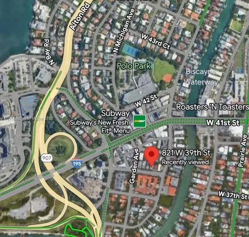 a view of empty room with wooden floor and window