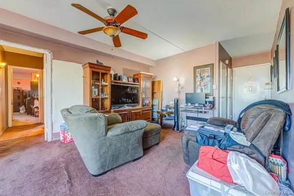 a living room with furniture or couch and a chandelier