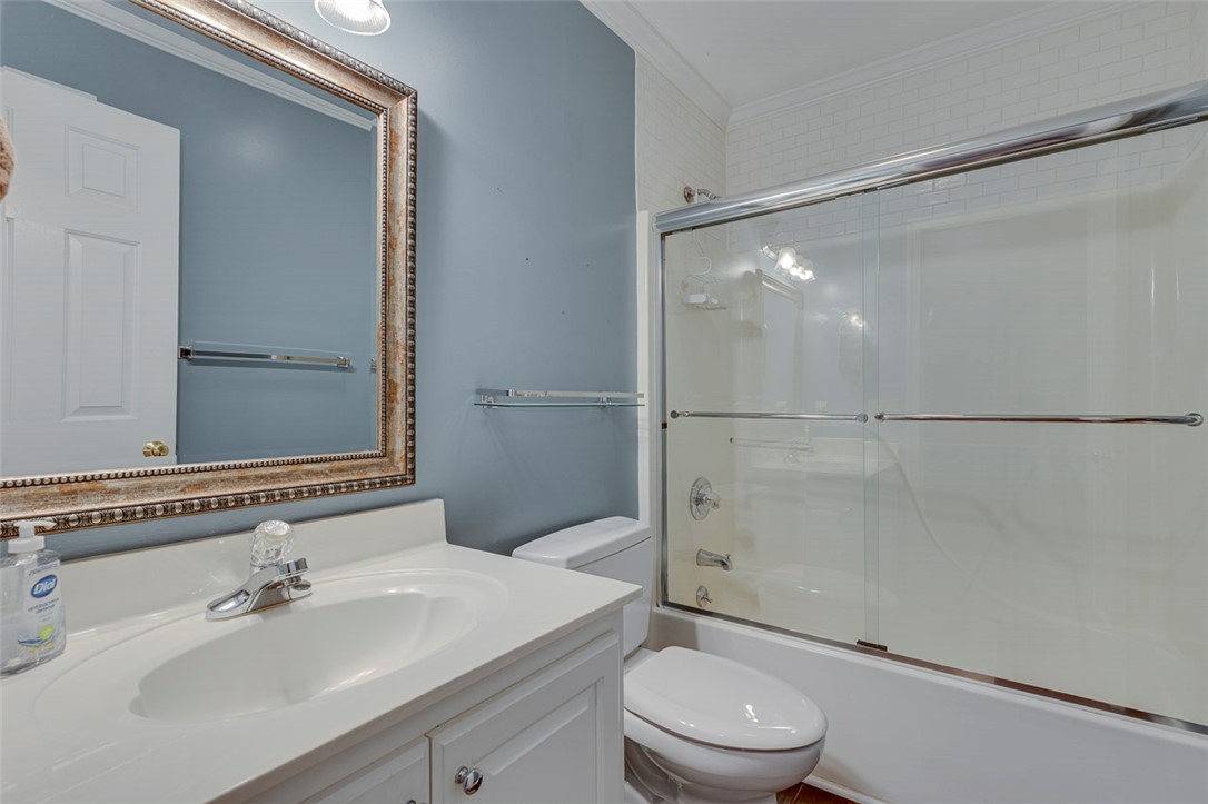 302 Wild Rice Drive Simpsonville, SC 29681 - Photo 32 of 44 Crisp white crown molding borders the ceiling above a tiled tub-shower surround.