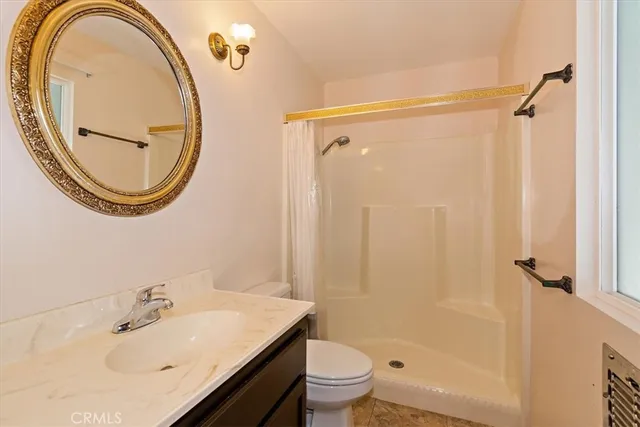 a bathroom with a sink a toilet and a mirror