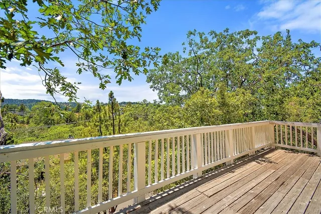 a view of balcony with wooden floor and fence