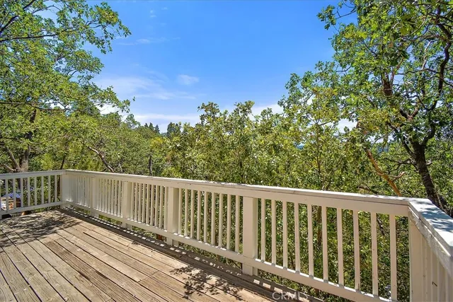 a view of a porch with wooden floor and fence