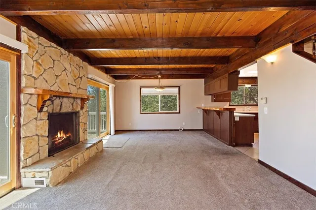 a view of open kitchen with a fireplace and window