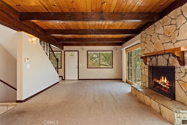 a view of an empty room with a fireplace