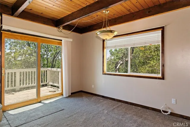a view of a room with wooden floor and a large window