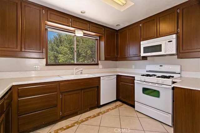 a kitchen with a stove sink and cabinets