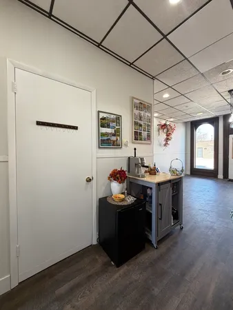 a view of a workspace with furniture and window