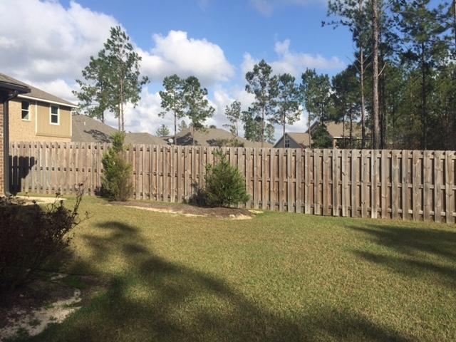 43 Secret Street Freeport, FL 32439 - Photo 56 of 77 a view of a yard with plants and wooden fence